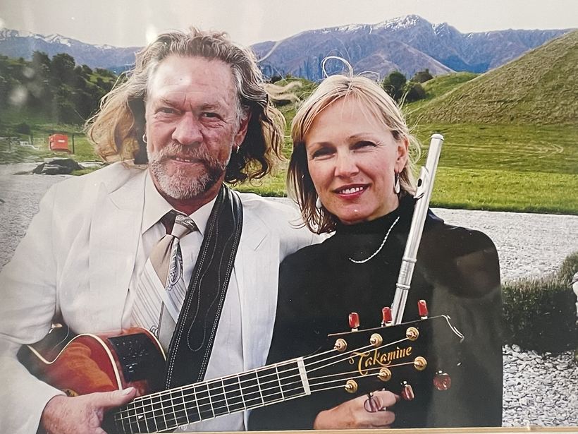 Suit, guitar, flute, mountains